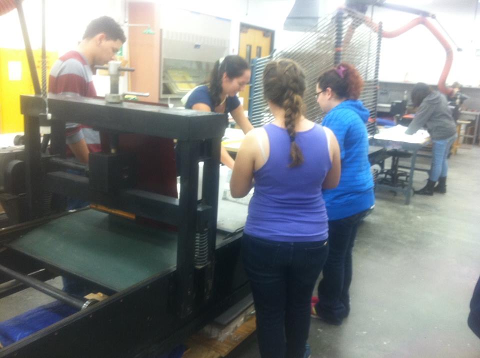 Laura and art students working on a litho stone
