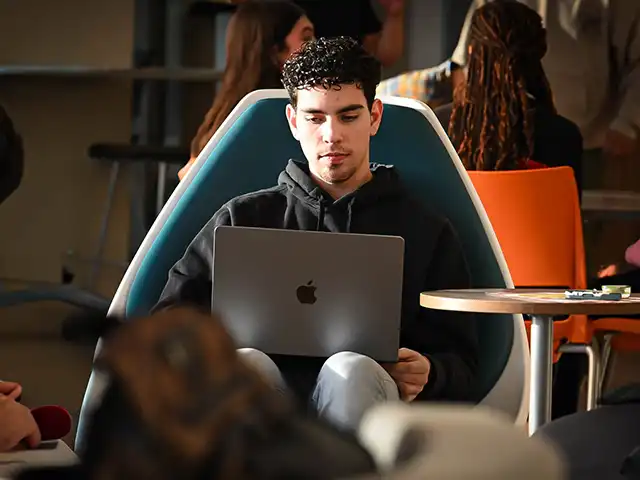 male student on his laptop