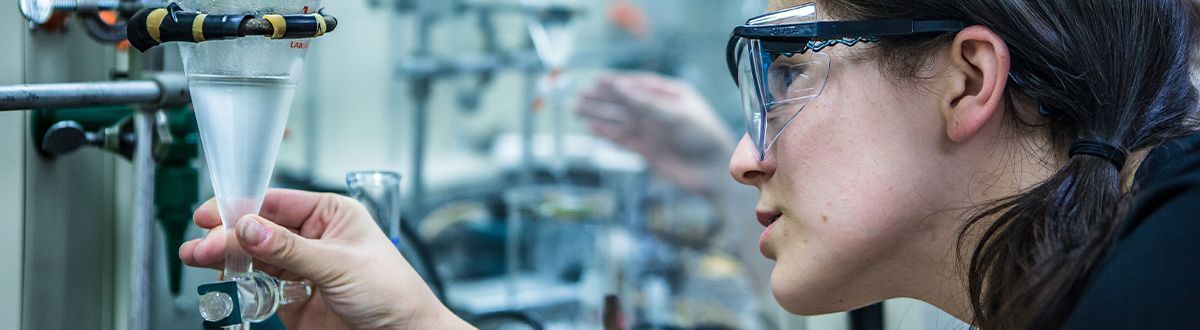 Student heating a test tube in a chemistry lab