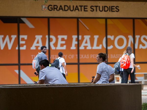 Students interacting in front of the fountain in the quad