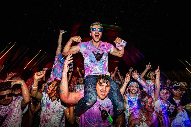 Students playing in glow paint at UTPB event