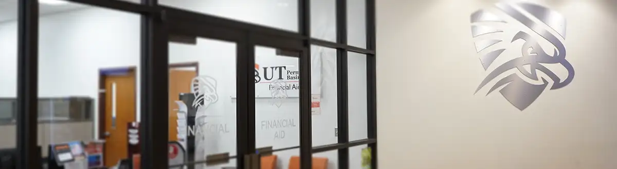 Financial Aid office doors with Falcon emblem on the wall