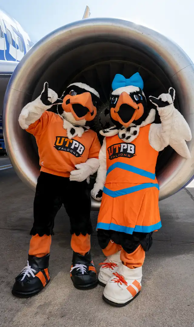 Freddy and Fiona in front of an airplane engine