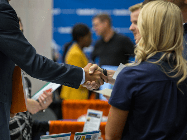 People shaking hands at a fair