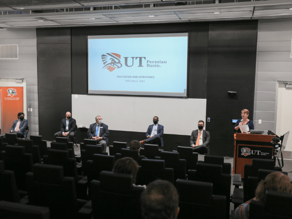 Deans and Dr. Woodley sitting in panel at press conference