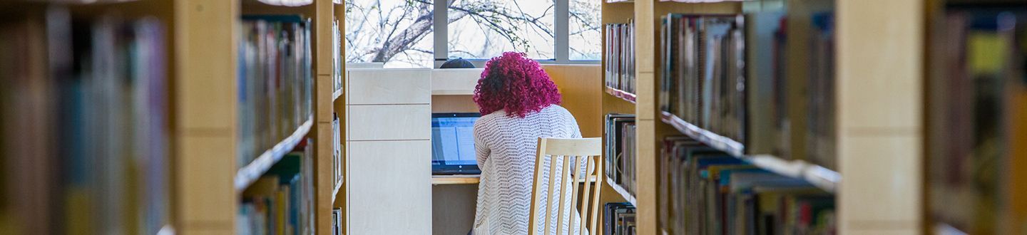 student sitting in the library