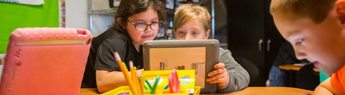 students looking at tablet