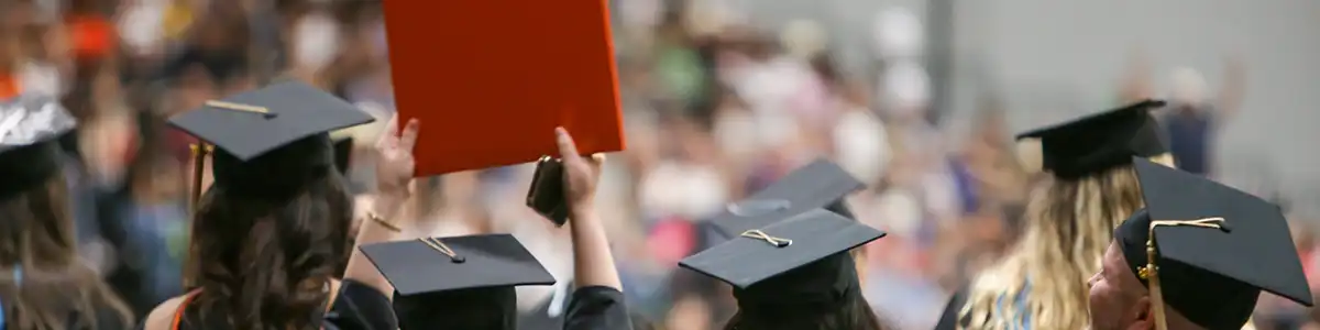 UTPB graduates holding up diploma