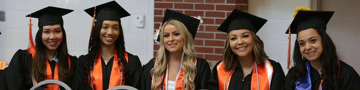 UTPB graduates smiling at the camera