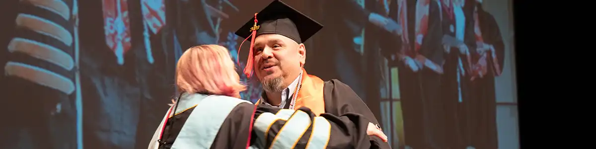 UTPB student walking the stage at graduation