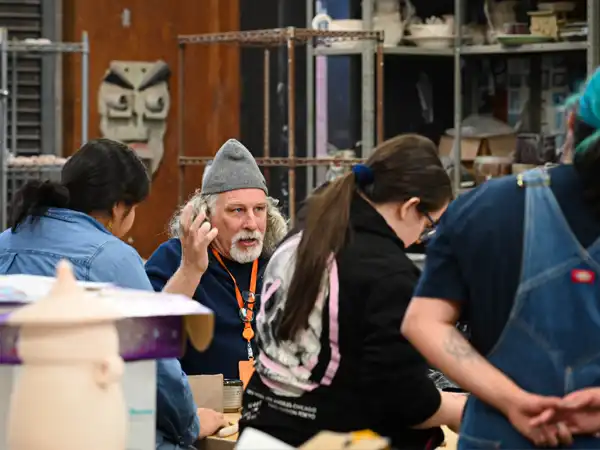 An Art Professor at UTPB teaching the students in the ceramics class prior to the students throwing on the pottery wheel. 