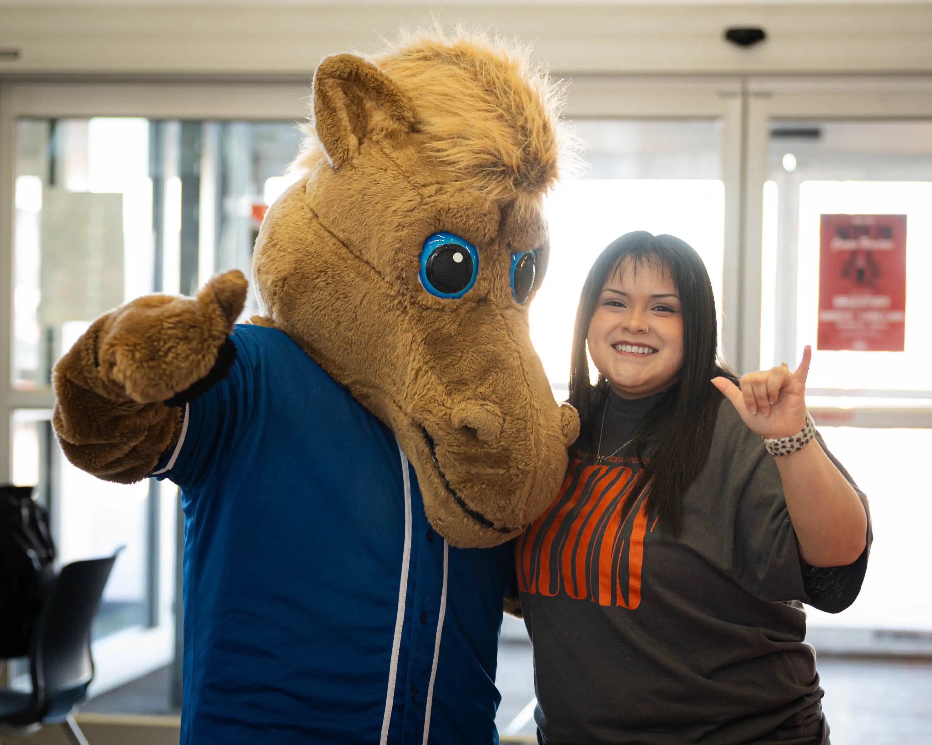 The Odessa College mascot pictured with a UTPB staff member at a transfer fair. 