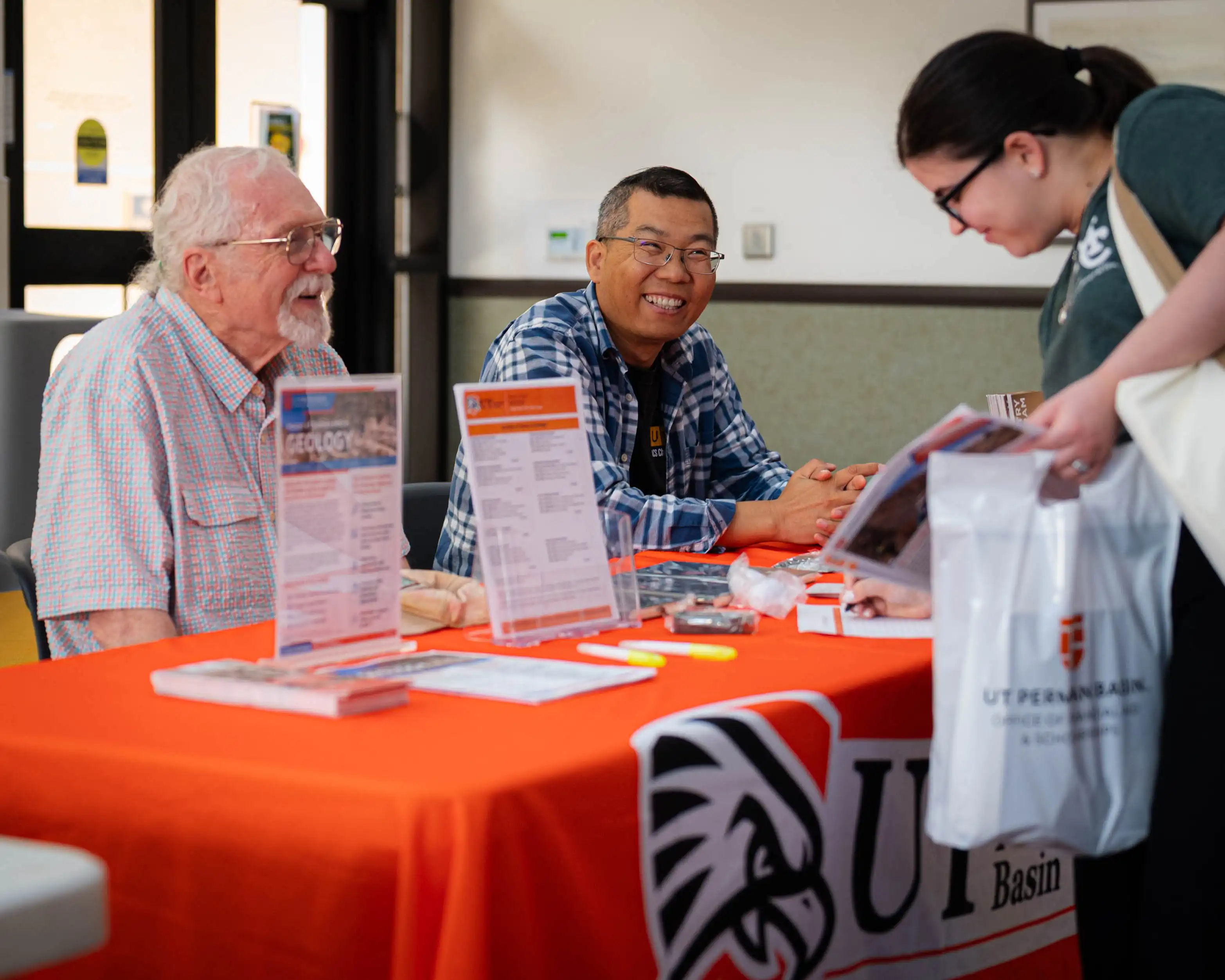UTPB faculty talking to a student at a Midland College transfer fair. 