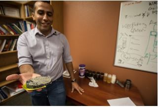 Image of Ahmed Alzahabi holding a rock sample