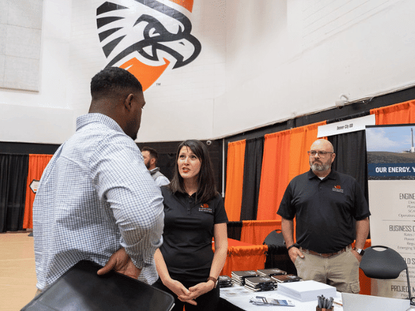 Student at career fair talking to employer