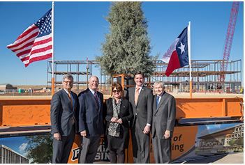 Image of Dr. Woodley and guests before the beam is raised