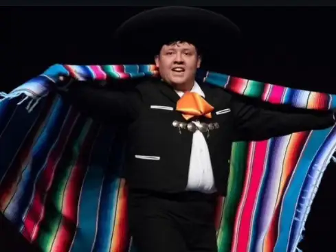 Sam Torres dances in his regalia during a ballet folklorico performance