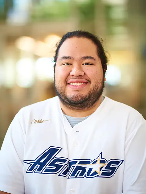 Samuel Mota smiling in a white Houston Astro's jersey