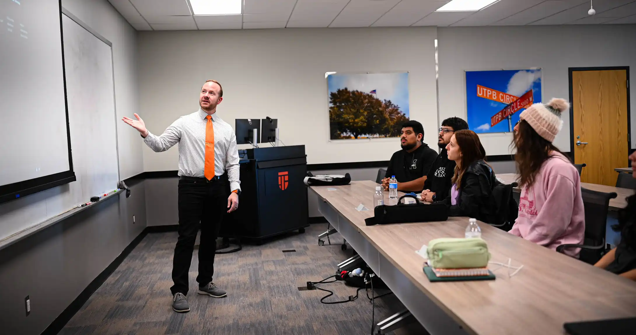 Eric Baker lecturing in class while modeling how to use the AI Teaching Assistant.