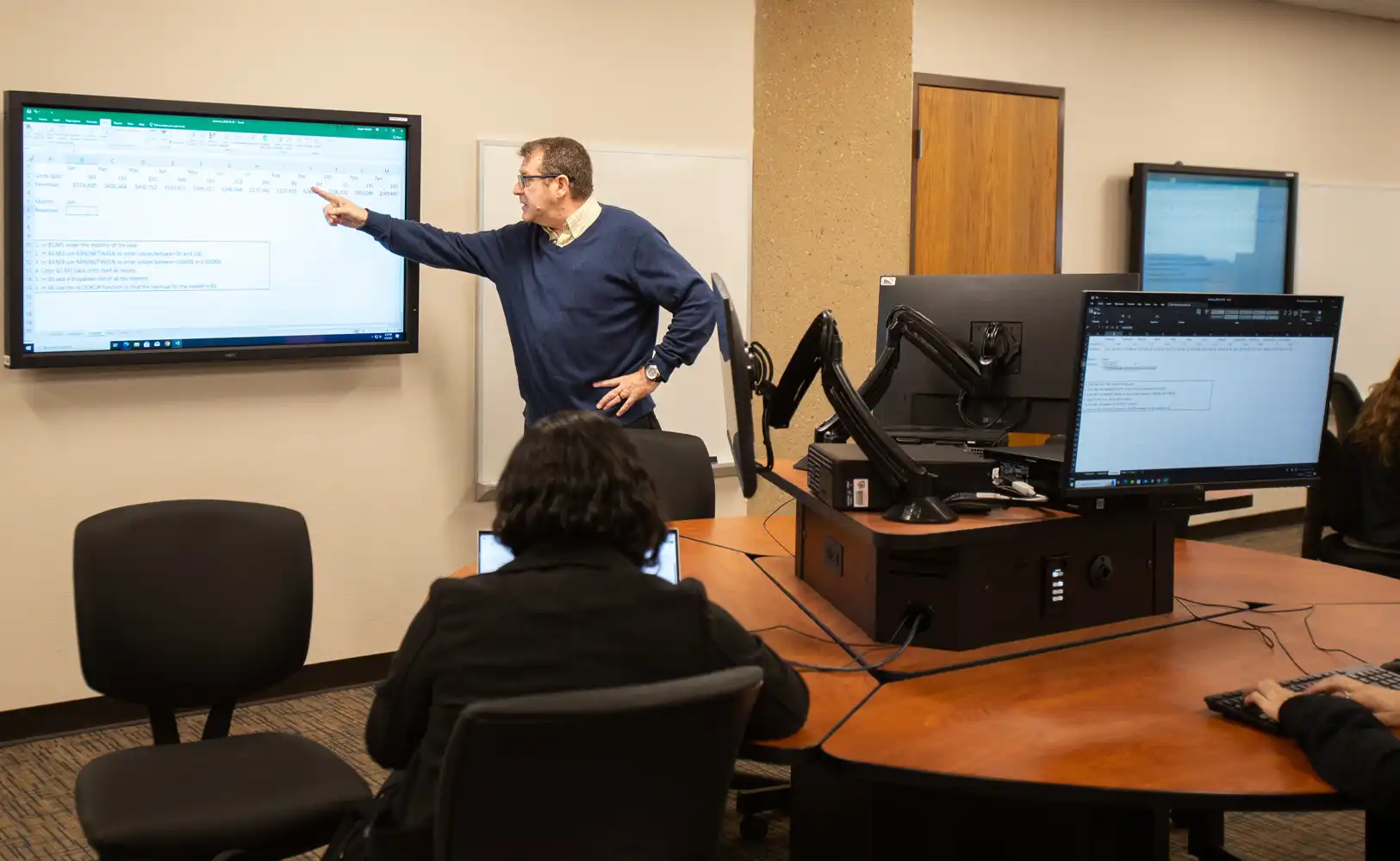 UTPB students participate in a MBA class, listening to a lecture and collaborating during a classroom discussion.