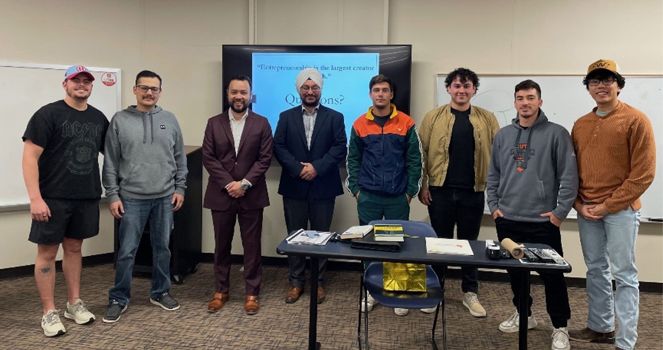 Students smiling for photo with class guest speaker