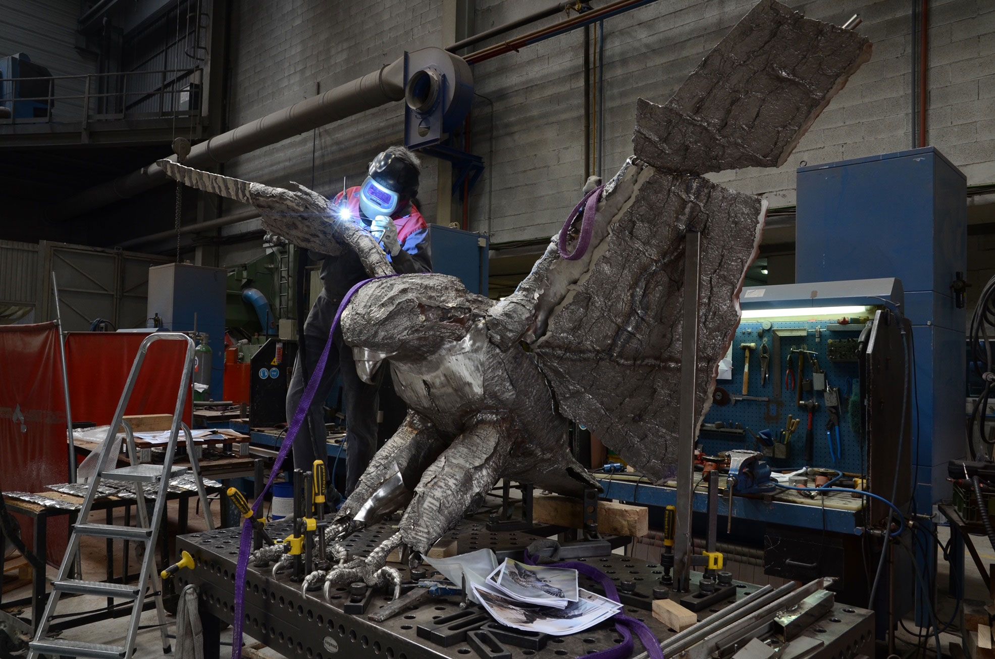 Artist KT welding Fiona Falcon in her studio