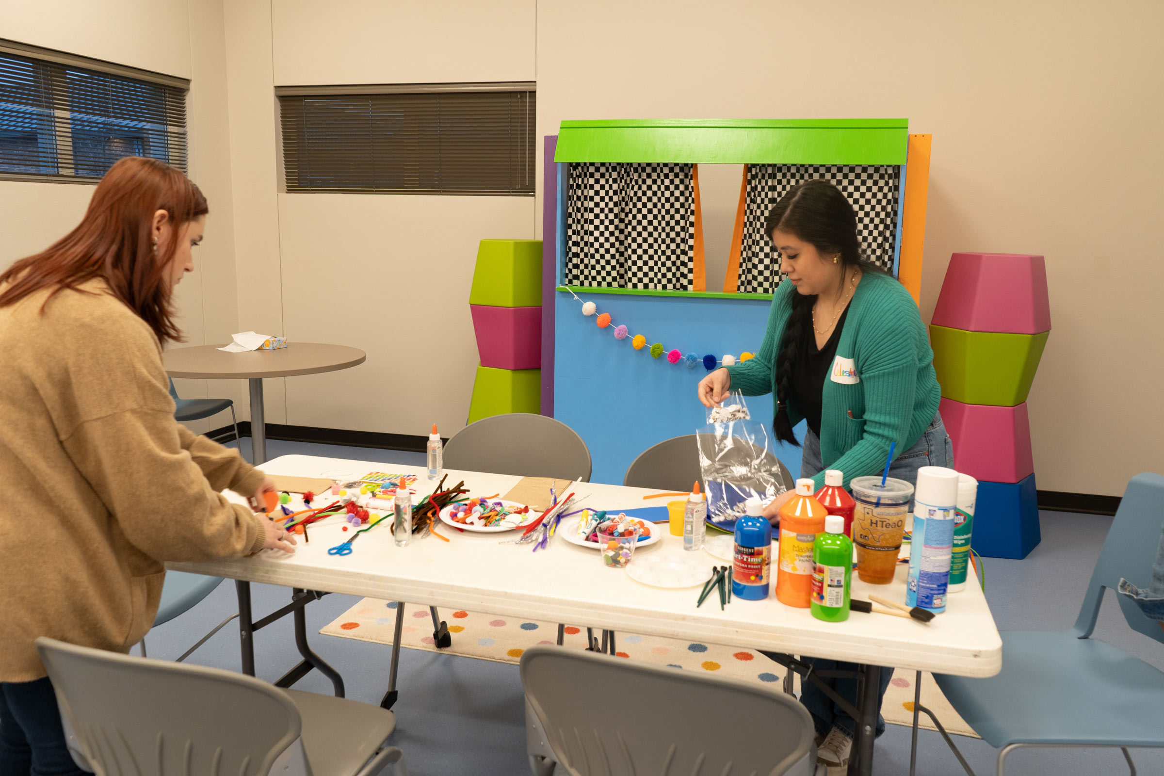 Two play therapy students setting up room at High Sky Children's Ranch