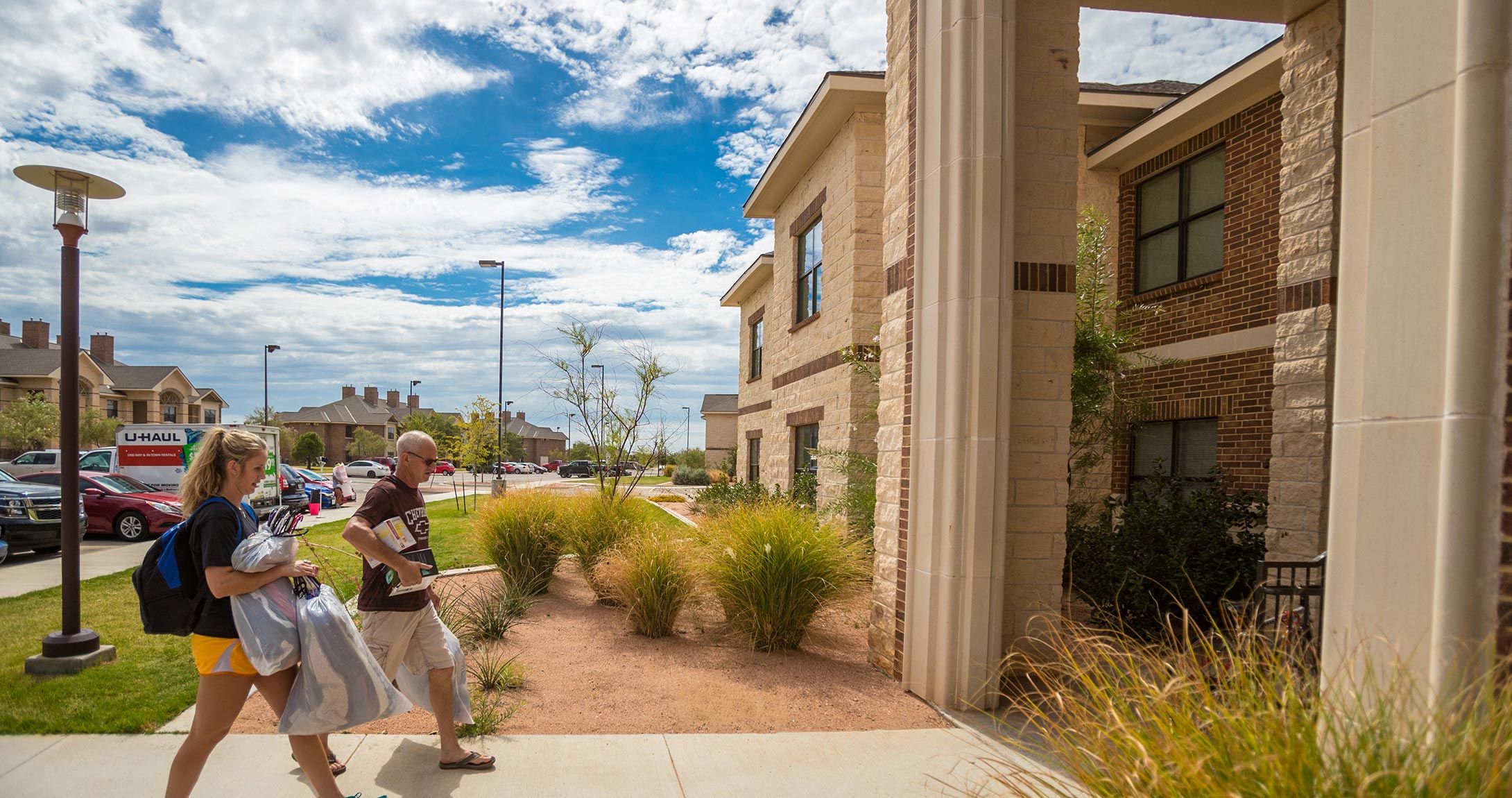 UTPB student and her dad walking into residence hall