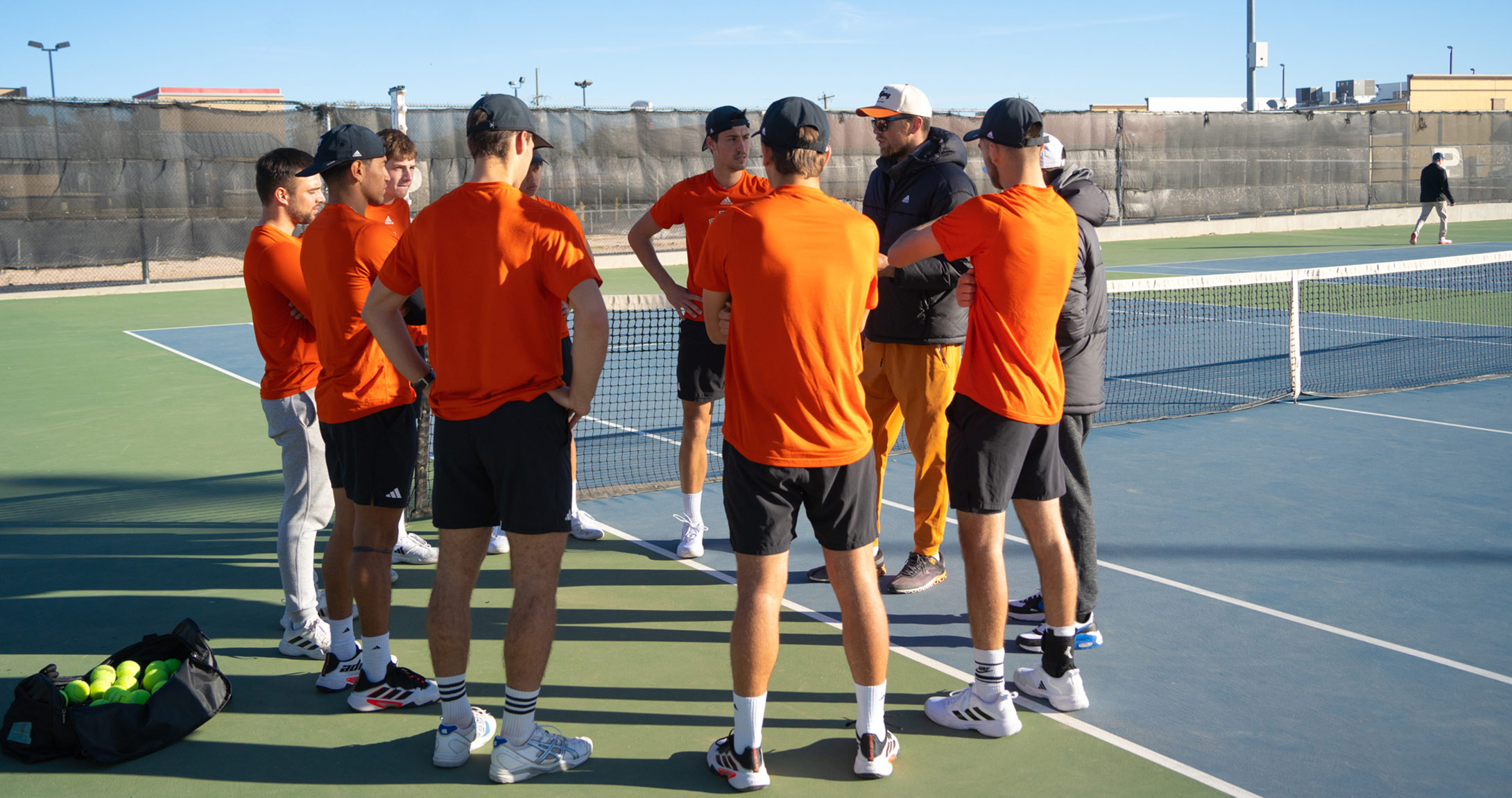 UTPB men's tennis team standing in circle 