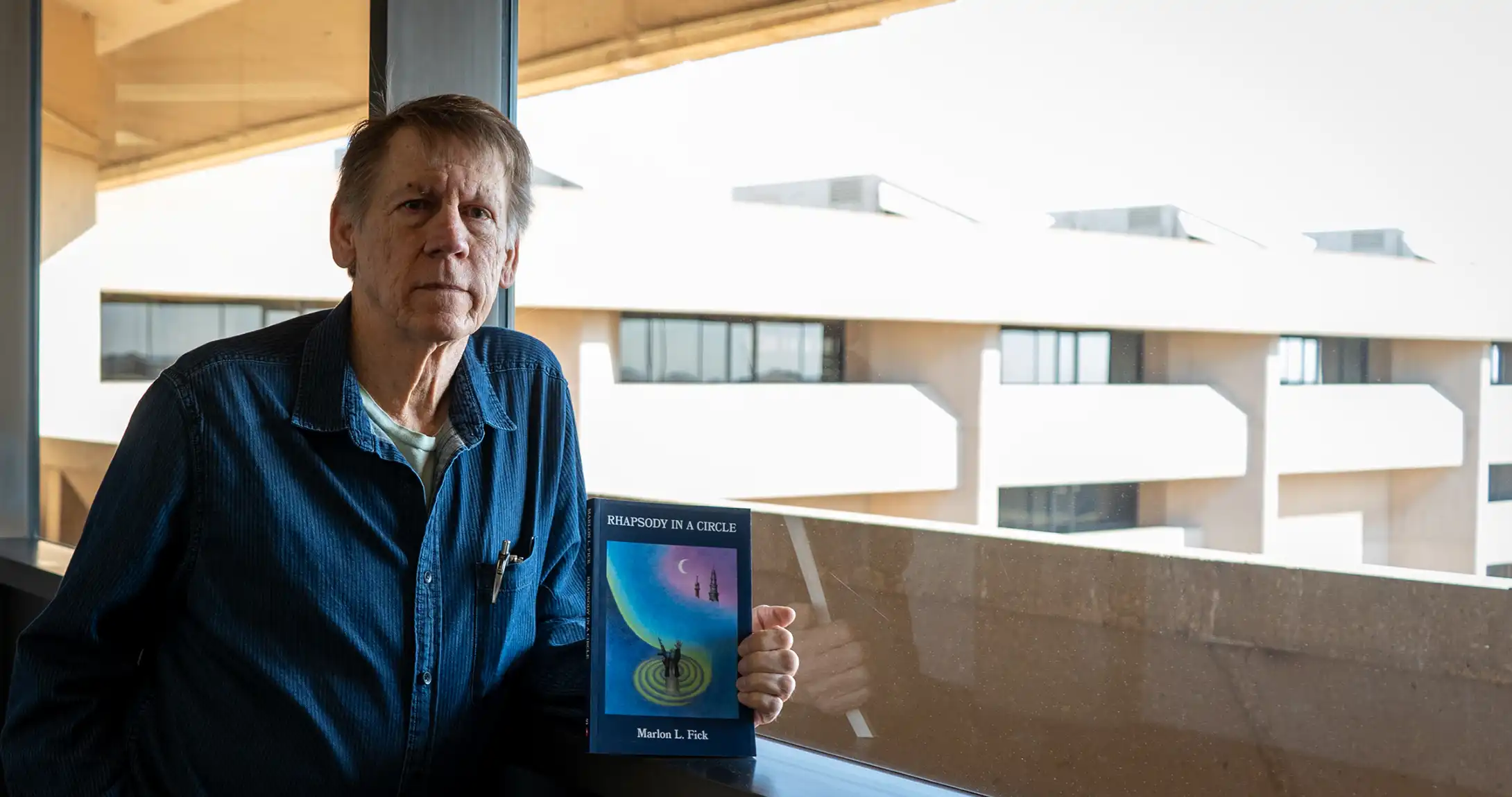 Marlon Fick posed with book, Rhapsody In a Circle