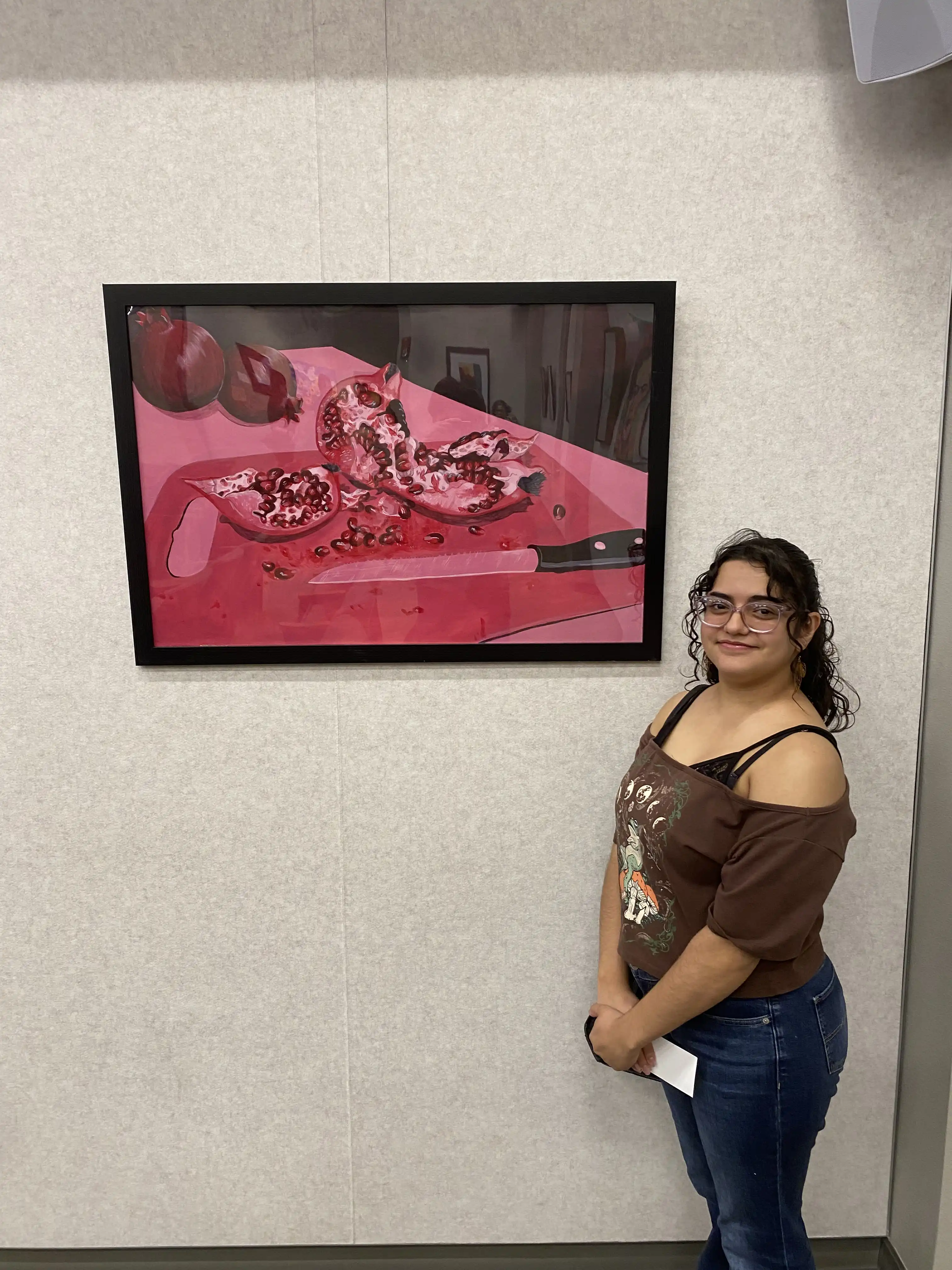 Tejeda standing by her painting