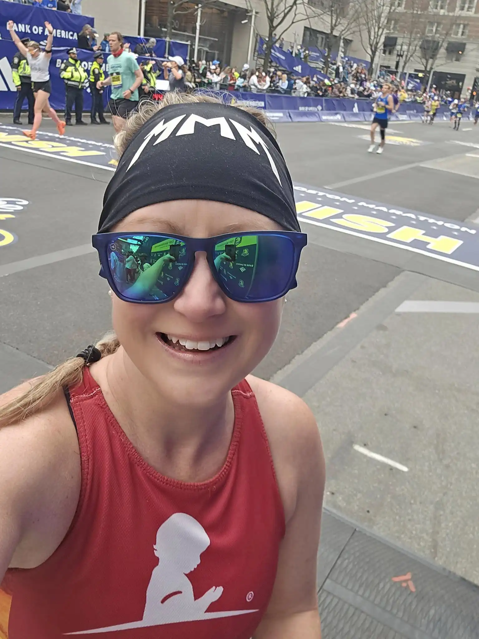 Terra James smiling at the camera while running Boston Marathon