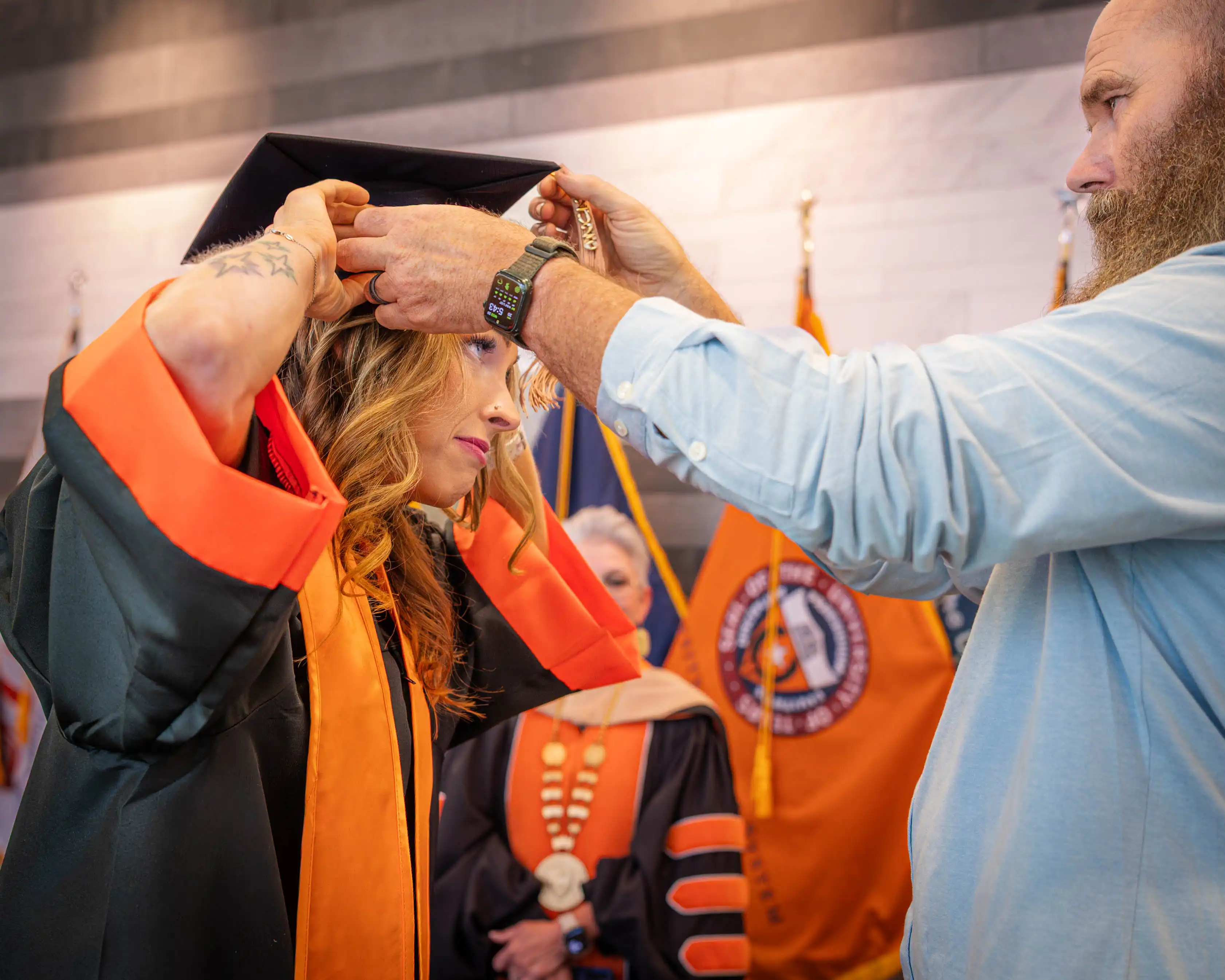 Avis Armstrong putting on her cap for her online graduation.