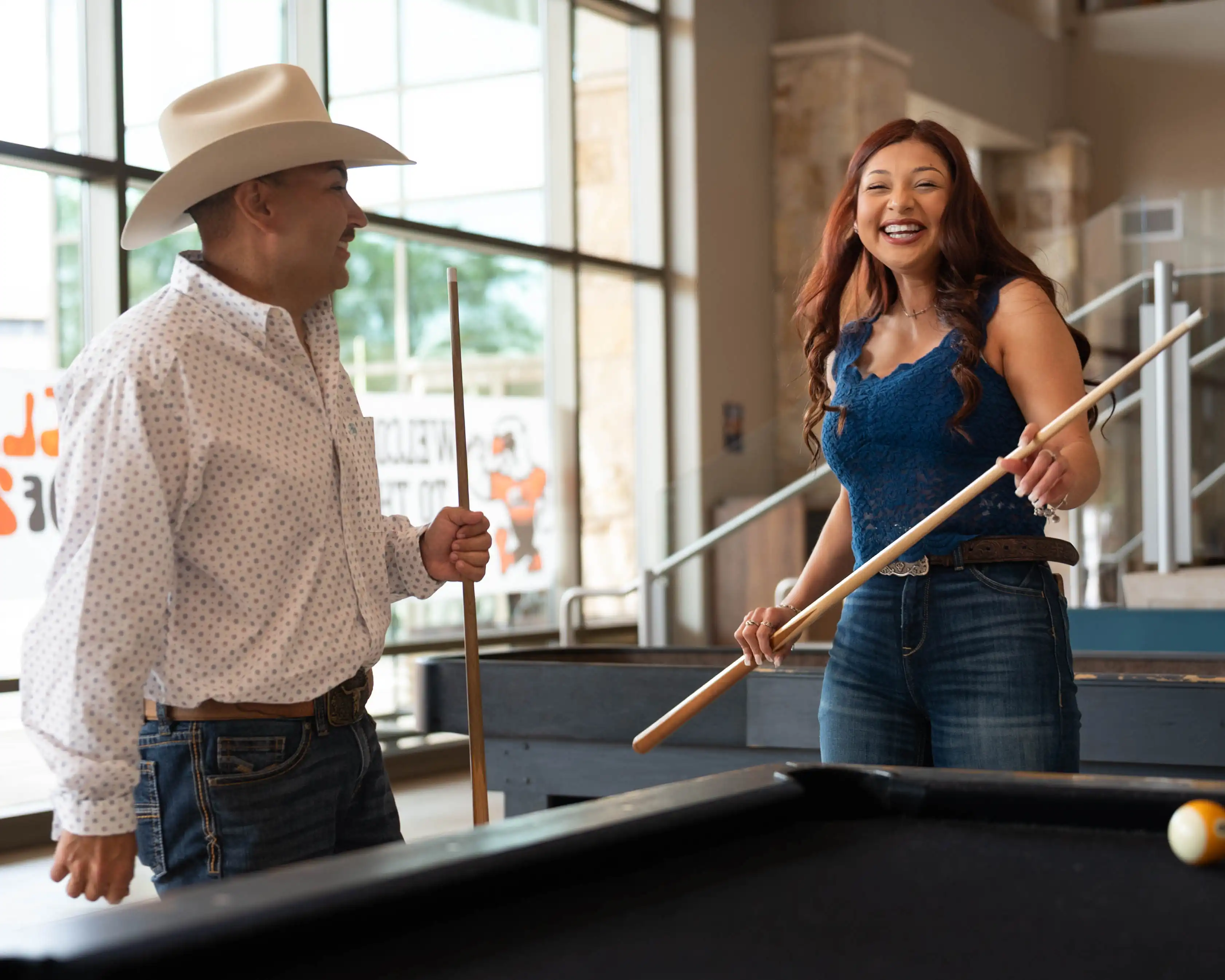 Stephanie and Christian playing pool together in the Student Activities Center. 