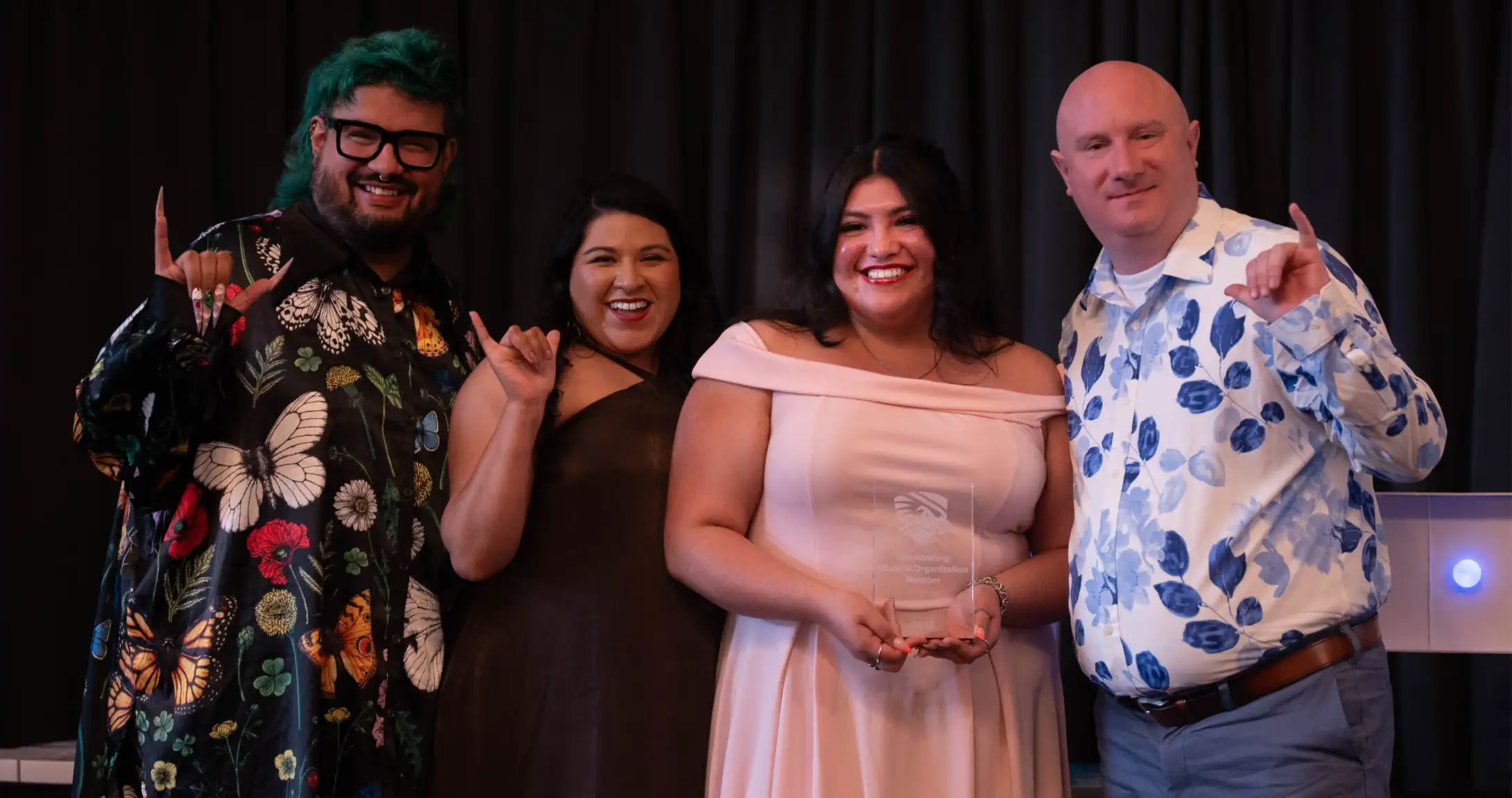 A group of people posing for a photo with the winner of one of the Freddy awards. 