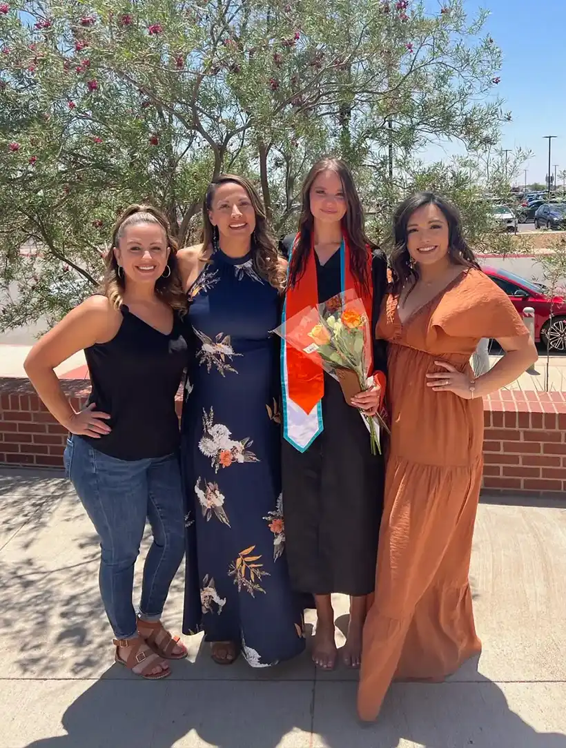 Heather celebrating her graduation with three family members.