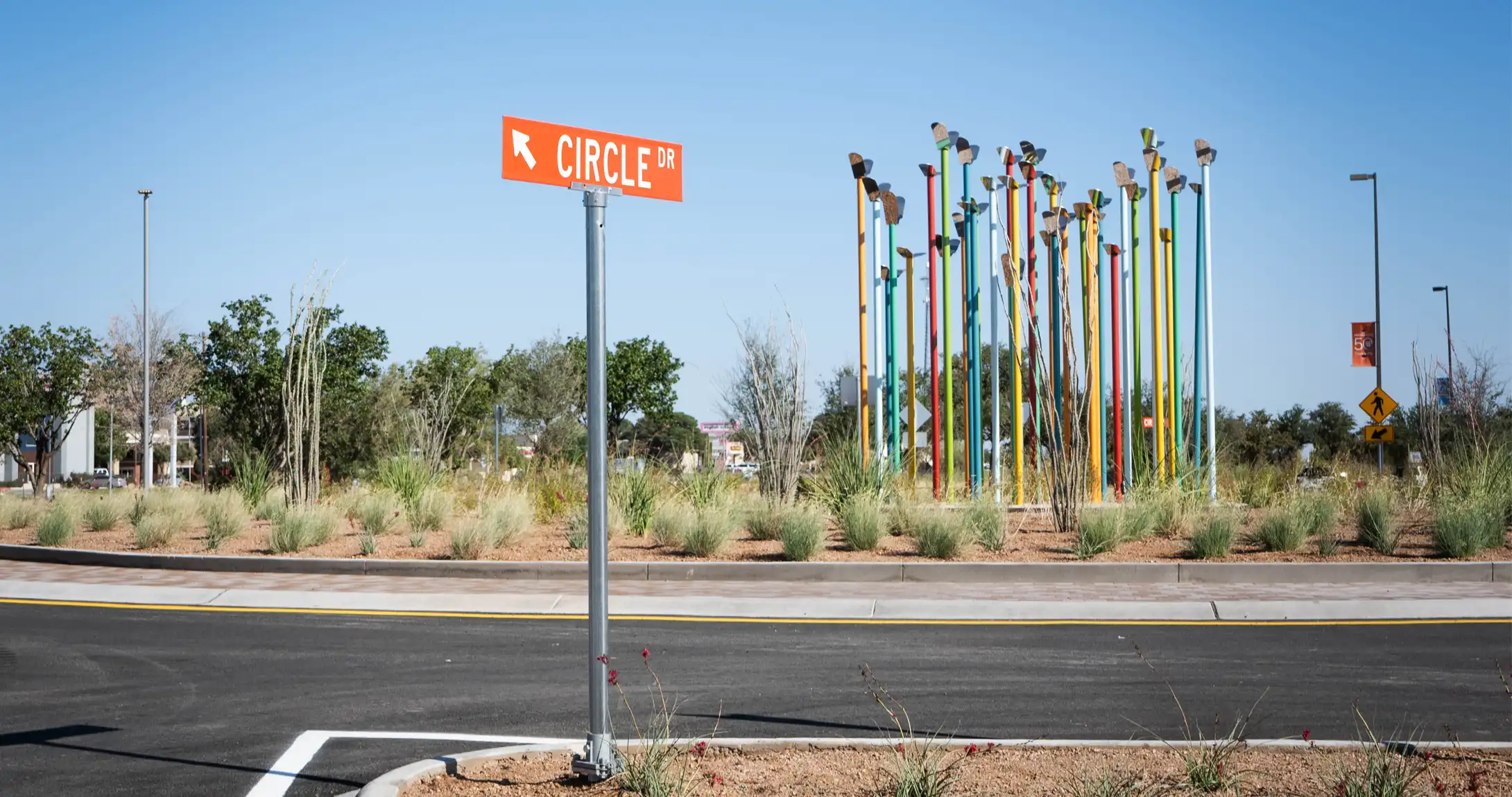 The Circle Drive street sign in front of the round about that features the "Time To Fly" artwork.