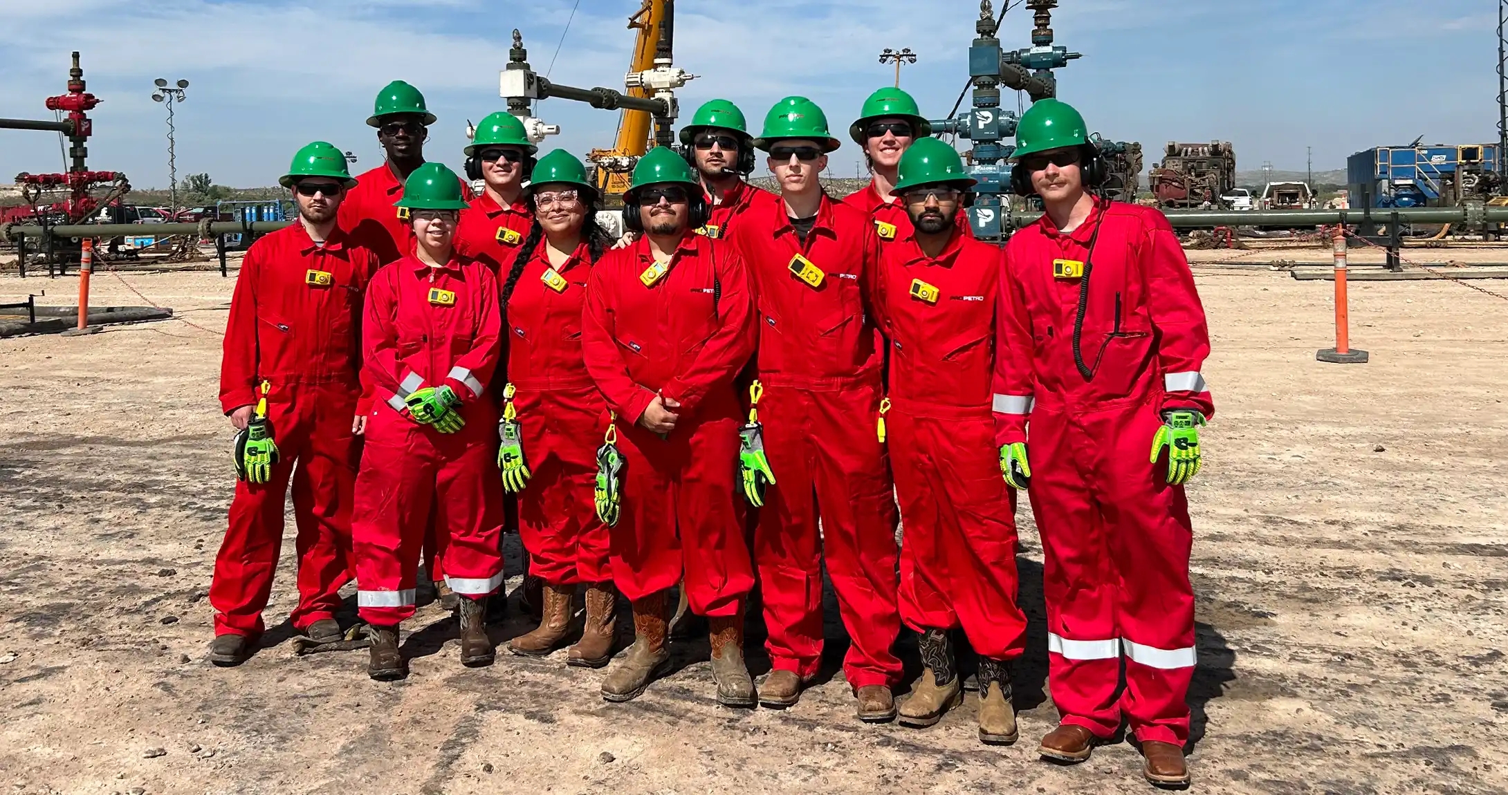 The ProPetro interns in a group in front of a well pad.