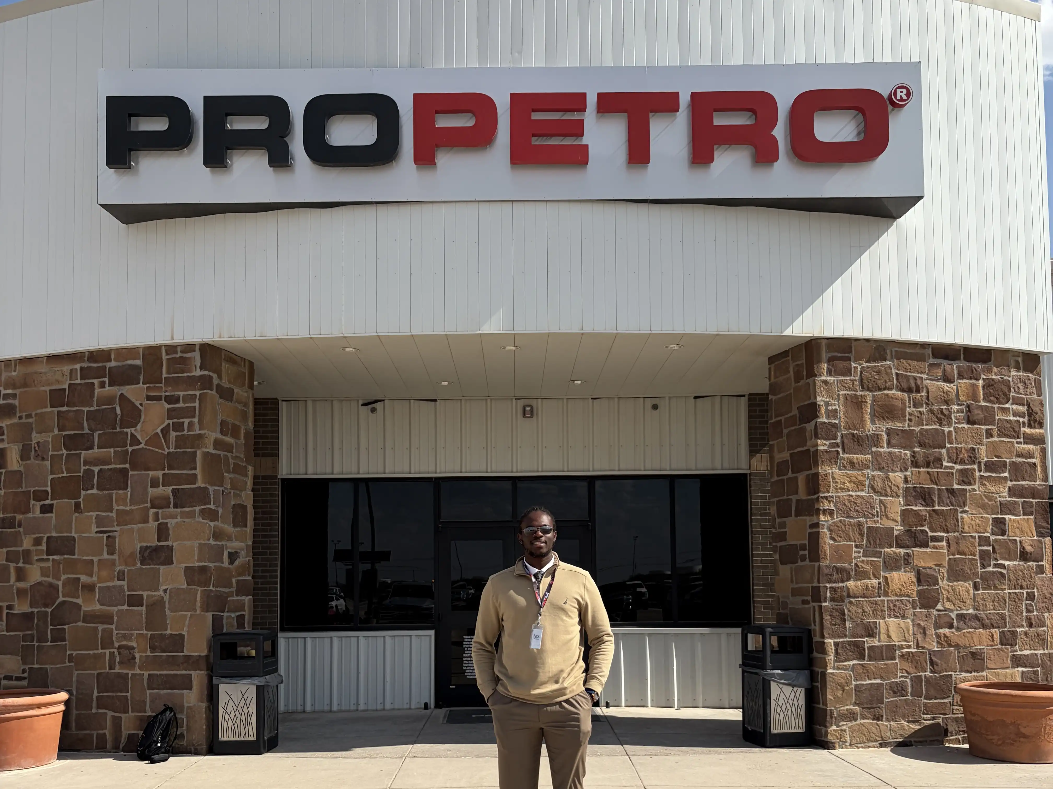 Bamidele standing in front of the ProPetro building. 