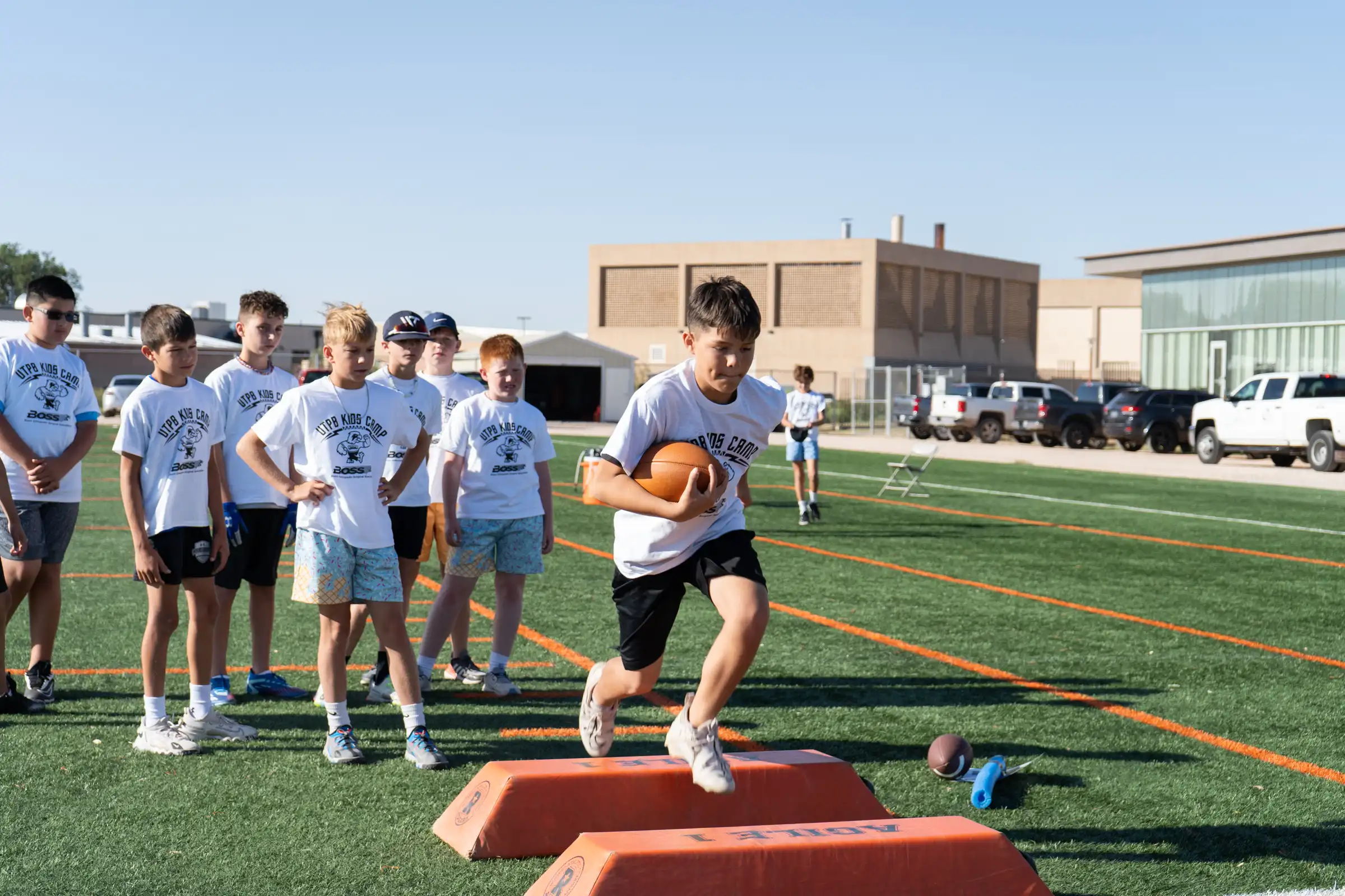 Camp participant doing football drills.