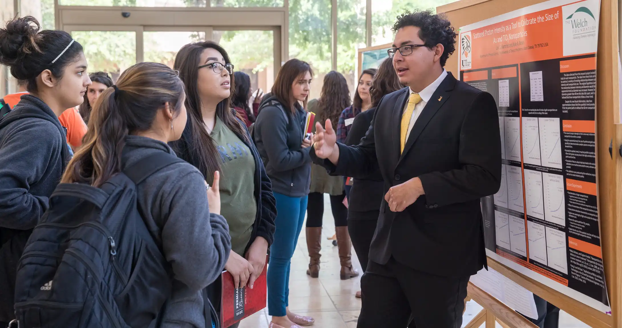 UTPB Students looking at a poster presentation at UTPB Research Day. 