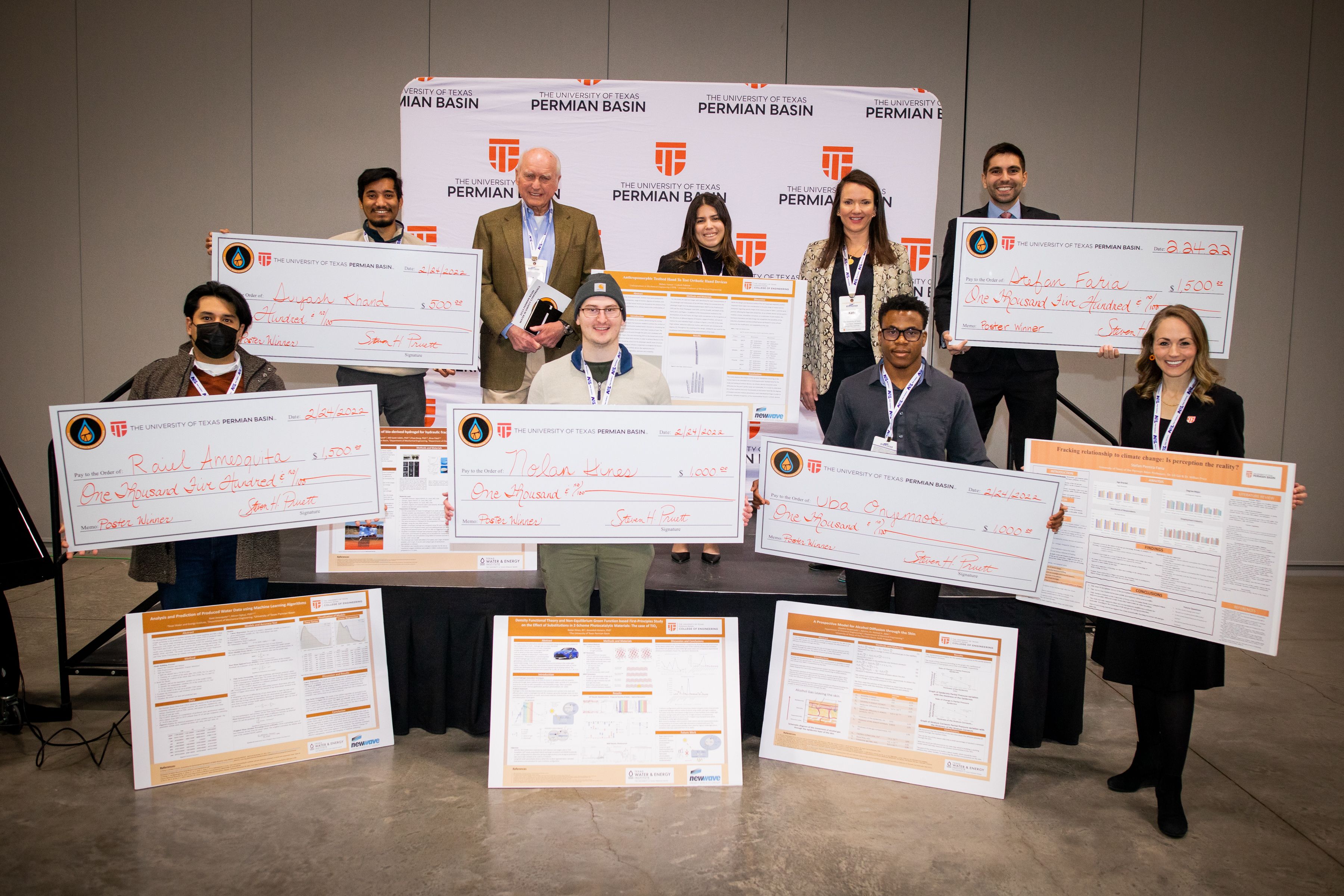 Scholarship award winners with their large checks