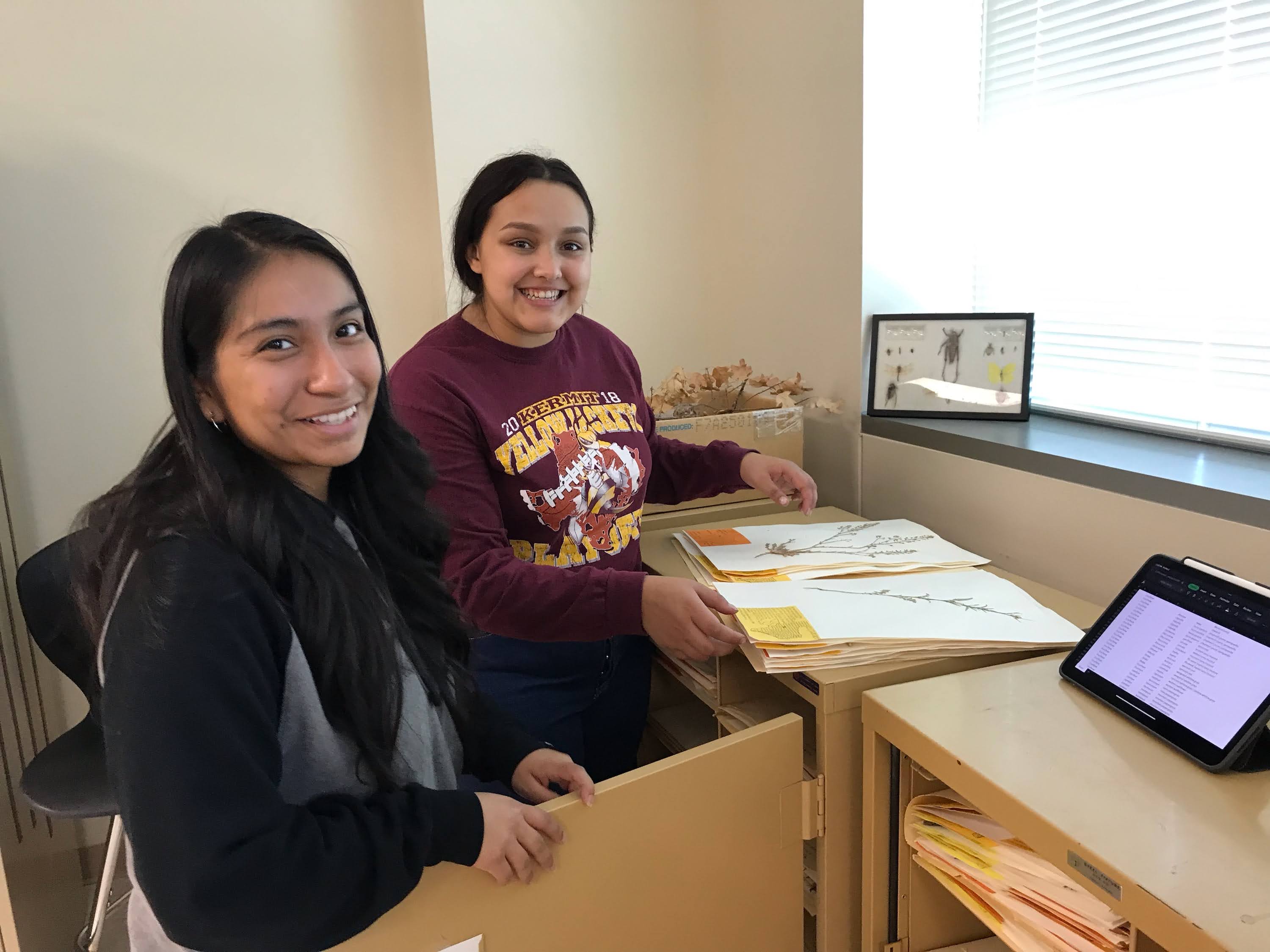 Analize and Jaqueline standing by their project