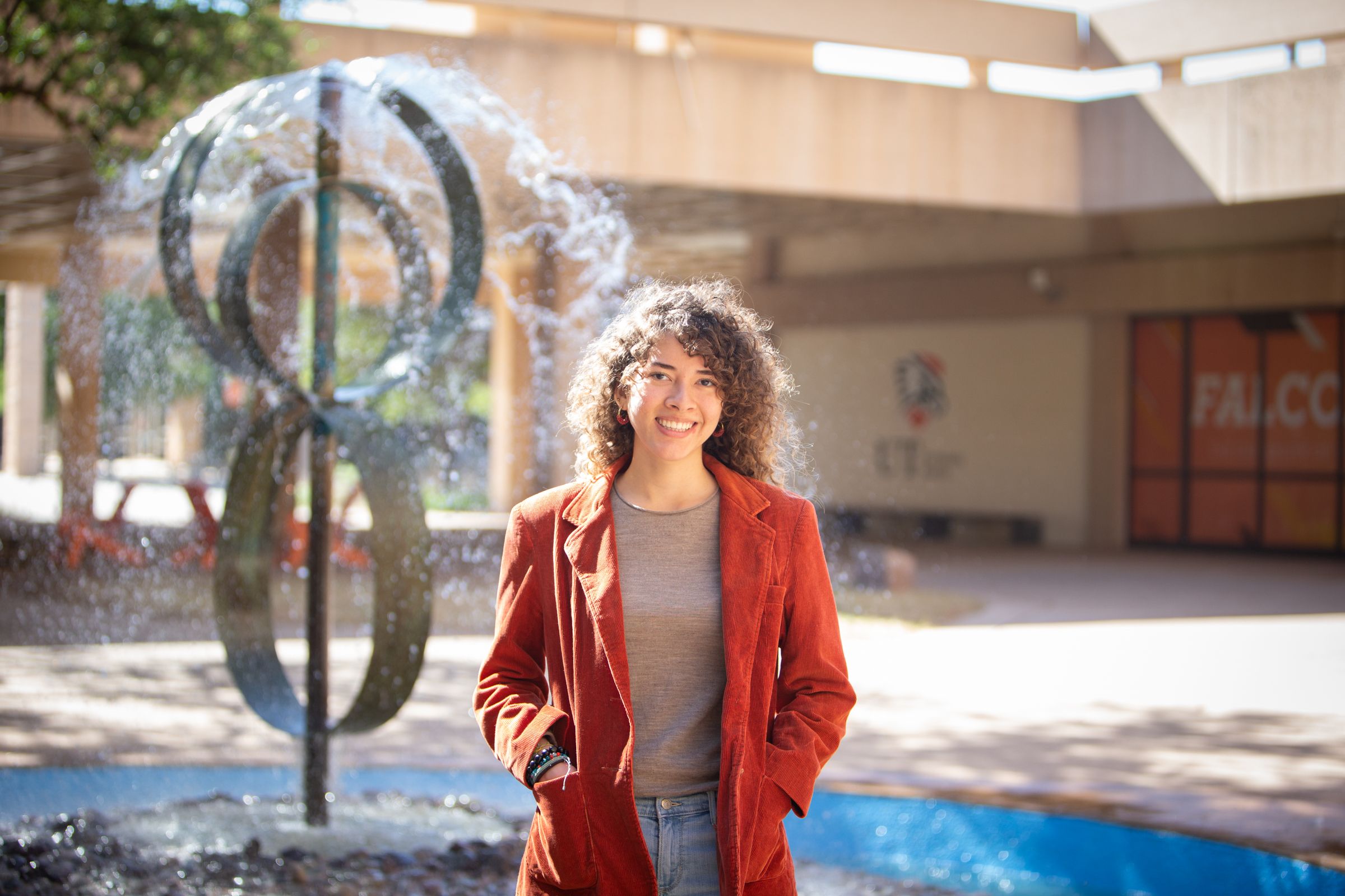 andrea soteldo in front of water fountain