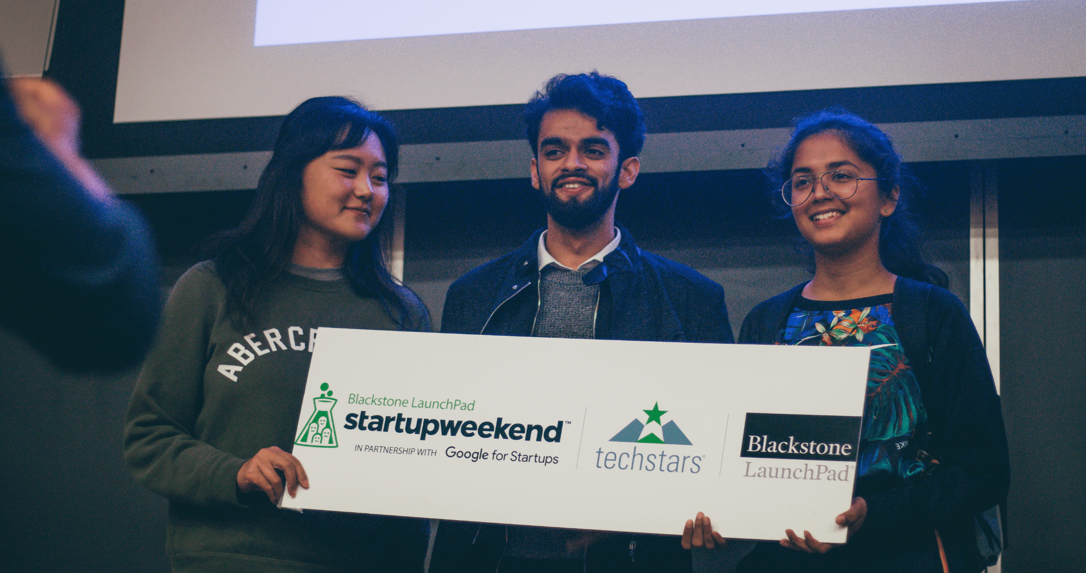 students holding Blackstone check