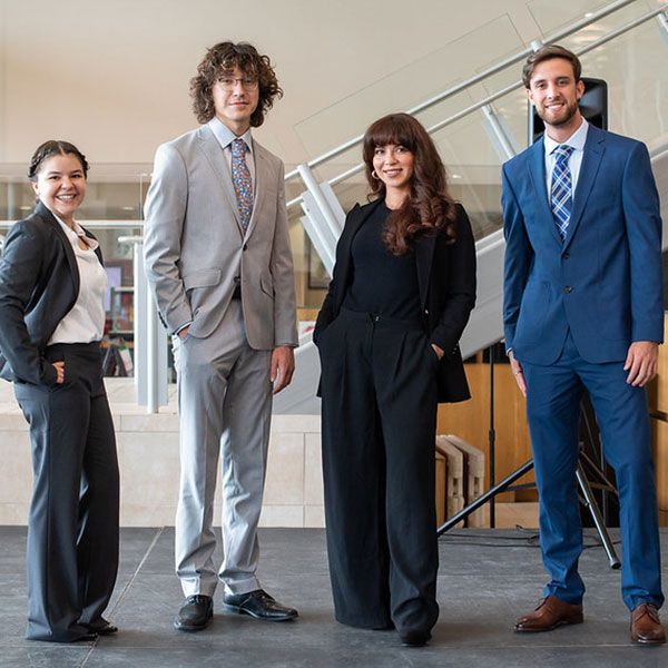 Business students dressed up posing at camera