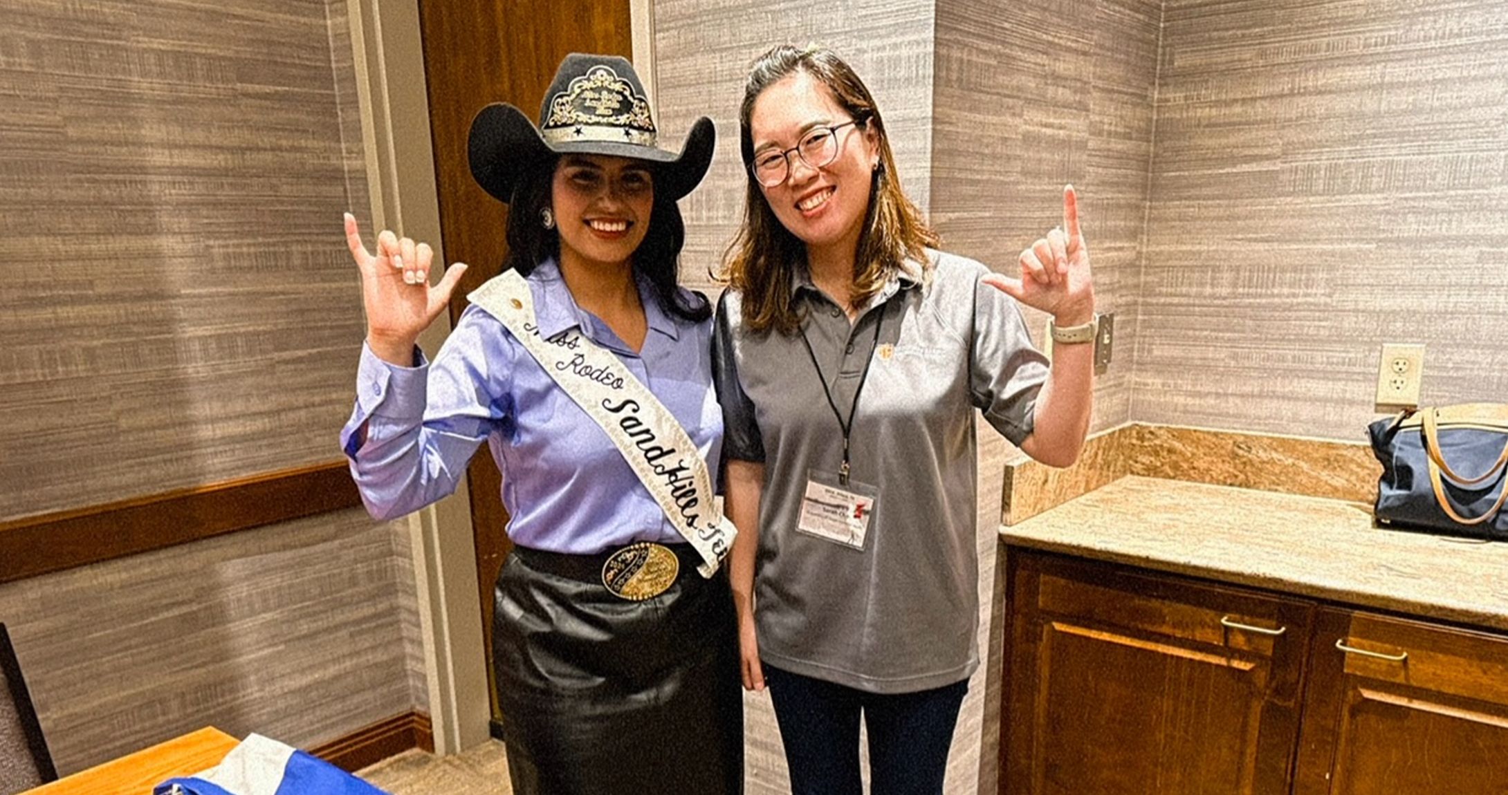 student and faculty member smiling at camera