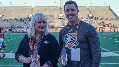 Two alumni being honored at football game