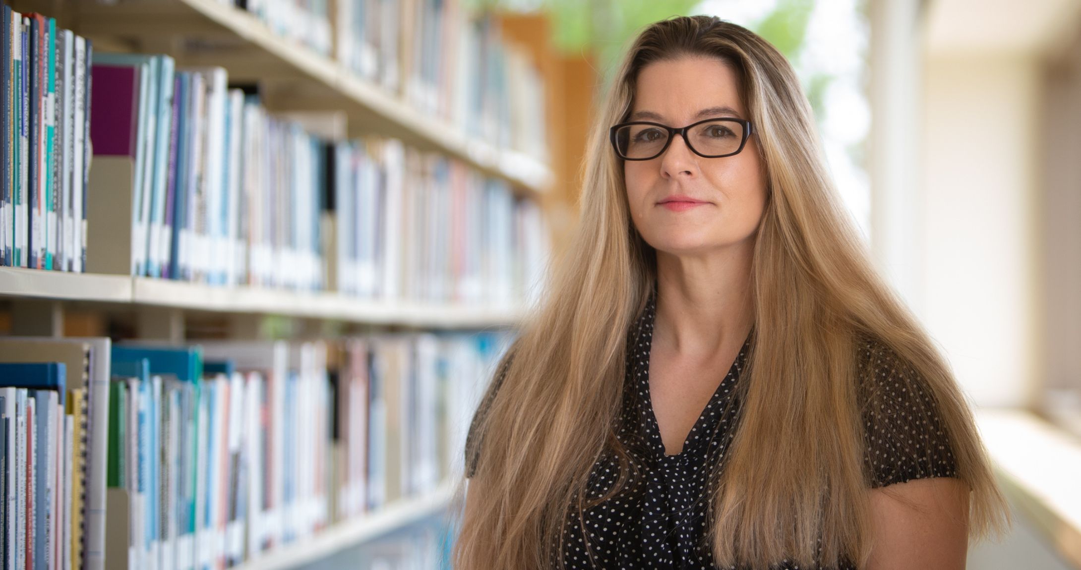 Dr. Jackson posing at library
