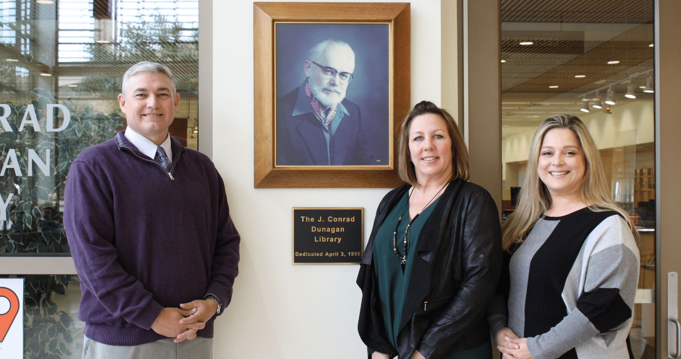 Permian Basin Area Foundation Representatives Standing in Front of Sign at the Library 